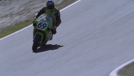 A-motorcycle-racer-leans-into-a-sharp-turn