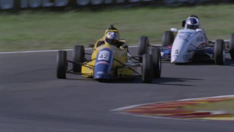 Formula-cars-race-on-a-circuit-track-1