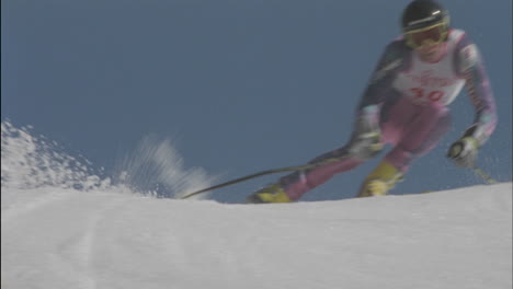 A-competitive-skier-skis-down-a-hill-and-snowflakes-fly