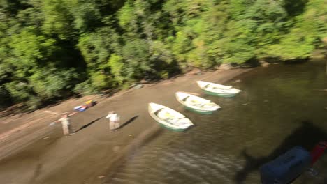 Aerial-view-of-a-helicopter-taking-off-from-a-beach-at-Ceasar-Lake-in-Parque-Nacional-Corcovado
