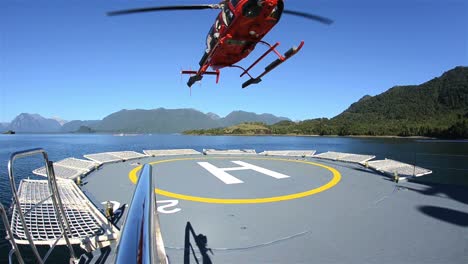 Low-angle-of-a-helicopter-taking-off-from-a-ship-helipad-near-Chait̩n-in-Northern-Patagonia-in-Chile