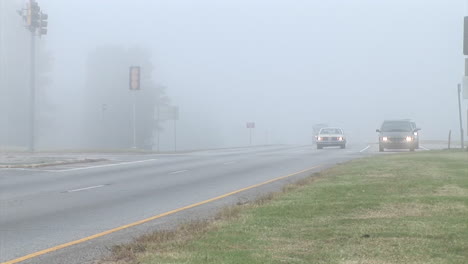 Cars-Travel-Along-A-Highway-In-The-Fog