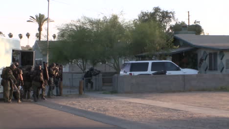 A-Swat-Team-Raids-A-Suspected-Drug-House-With-Weapons-And-Guns-Drawn