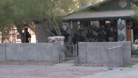 A-Swat-Team-Raids-A-Suspected-Drug-House-With-Weapons-And-Guns-Drawn-1