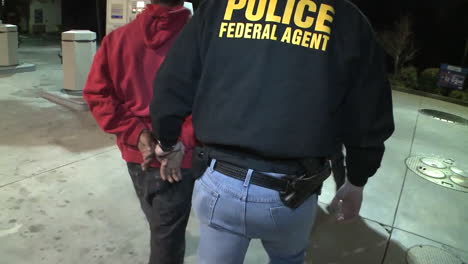 Federal-Agents-Handcuff-And-Lead-Away-A-Suspect-For-Drug-Crimes