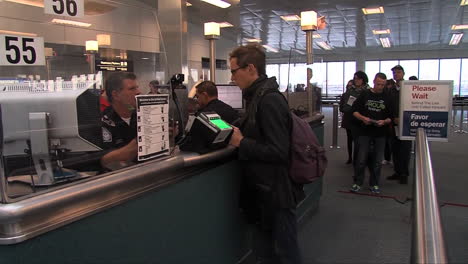 Arriving-Passengers-Passports-Are-Checked-By-Homeland-Security-At-An-Airport-2