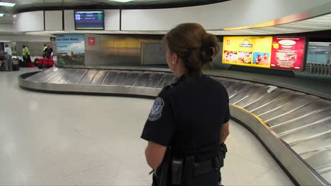 A-Homeland-Security-Agent-Walks-Through-An-Airport