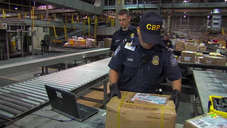 Homeland-Security-Agents-Search-A-Suspicious-Package-In-A-Shipping-Facility-And-Discover-Hidden-Drugs