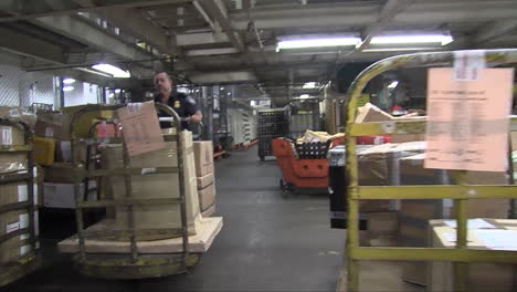 Homeland-Security-Agents-Search-Through-A-Warehouse-In-A-Shipping-Facility-2