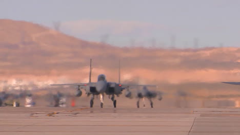 F15-And-F16-Fighter-Jets-Line-Up-And-Taxi-For-Takeoff-In-A-Military-Exercise