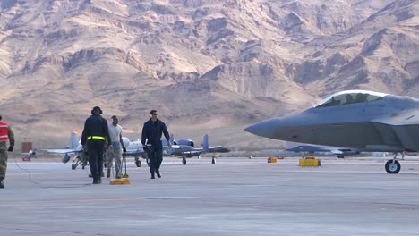Maintenance-Workers-On-An-Air-Force-Runway-With-F15-And-F16-Jet-Fighters-In-Background