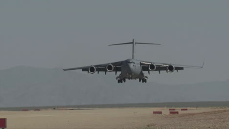 A-C130-Cargo-Plane-Lands-On-A-Dirt-Runway-In-The-Desert