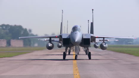Numerous-F15-And-F16-Fighter-Jets-Line-Up-And-Taxi-For-Takeoff-In-A-Military-Exercise-1