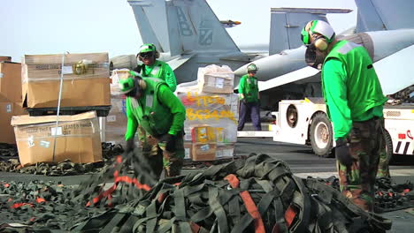 Goods-Are-Stacked-On-The-Deck-Of-An-Aircraft-Carrier-During-A-Replenishment-At-Sea-Exercise