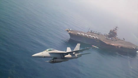 Aerials-Of-Jet-Fighter-Planes-Passing-An-Aircraft-Carrier-At-High-Speed