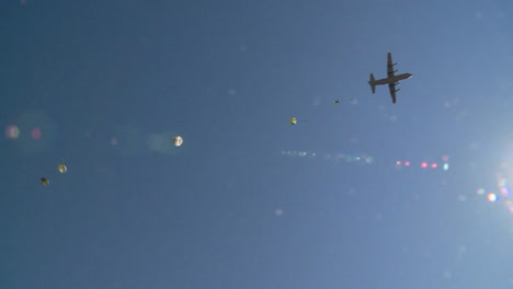 Ground-Angle-View-Of-Paratroopers-Parachuting-To-Earth