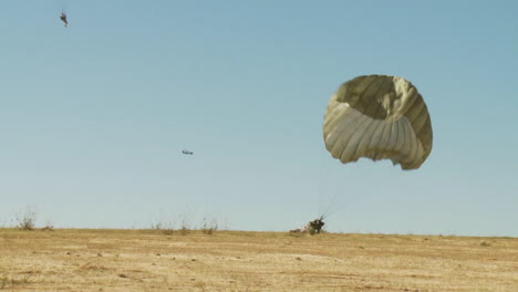 Ground-Angle-View-Of-Paratroopers-Parachuting-To-Earth-1