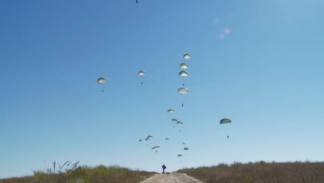 Ground-Angle-View-Of-Paratroopers-Parachuting-To-Earth-From-A-C17-1