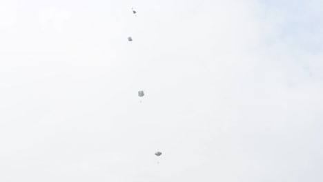Ground-Angle-View-Of-Paratroopers-Parachuting-To-Earth-From-A-C17-2