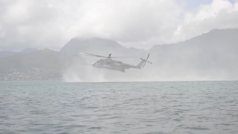 Navy-Seals-Train-On-Rubber-Zodiac-Watercraft-While-A-Helicopter-Performs-A-Helicasting-Maneuver