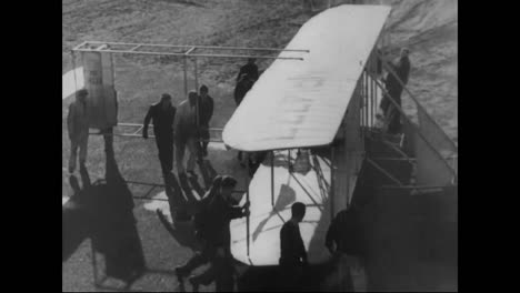 A-Replica-Of-The-Kitty-Hawk-Flies-At-Camden-New-Jersey-In-The-1930S-And-Biplanes-Fly-Over-Manhattan