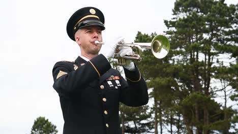 An-American-Soldier-Holds-A-Bugle-Up-To-His-Mouth-But-Does-Not-Play-At-The-Graveyard-Near-Normandy-Beach-75Th-Anniversary-Of-Dday-2019