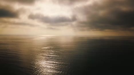 Aerial-Over-Fog-On-A-Golden-Calm-Ocean-Scene-Suggests-Inspiration-And-Wonder