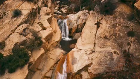 Pulling-Back-Aerial-Of-A-Small-Waterfall-And-Stream-In-The-Los-Padres-Wilderness-Mountains-Behind-Ojai-Valley-California