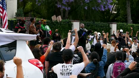 Protesters-Hold-Up-Fists-And-Listen-To-Speaker-During-A-Black-Lives-Matter-Blm-March-In-Los-Angeles-Following-The-George-Floyd-Murder