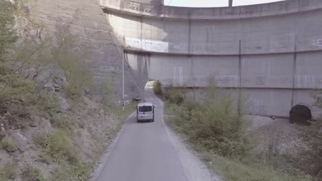Drone-Aerial-Follows-A-Van-Through-A-Hole-In-The-Controversial-Idbar-Dam-In-Bosnia