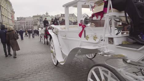 Horses-And-Carriages-Pass-On-The-Streets-Of-Krakow-Poland