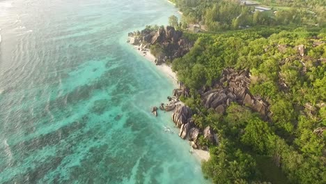 An-aerial-view-shows-gentle-waves-rippling-towards-La-Digue-island-in-the-Seychelles