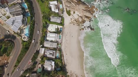 A-bird'seyeview-shows-cars-driving-by-the-beach-of-Camps-Bay-in-Cape-Town-South-Africa