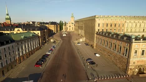 An-aerial-view-pulls-away-from-the-Royal-Palace-in-Stockholm-Sweden-to-show-boats-docked-nearby