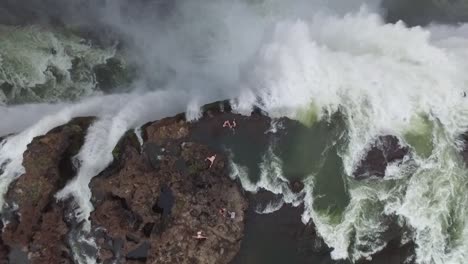 A-bird'seyeview-shows-tourists-swimming-atop-Victoria-Falls-at-the-Devil's-Pool-in-Zambia