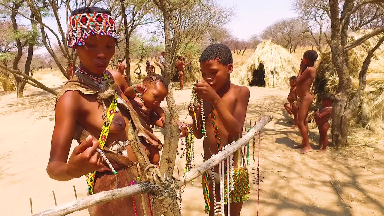 African San Tribal Bushmen Family At Their Huts In A Small Primitive Village  In Namibia Africa Free Stock Video Footage Download Clips Culture