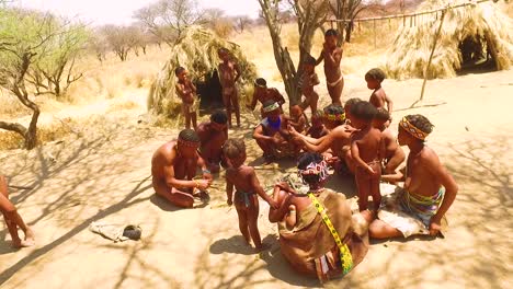 African-San-tribal-bushmen-family-at-their-huts-in-a-small-primitive-village-in-Namibia-Africa-1