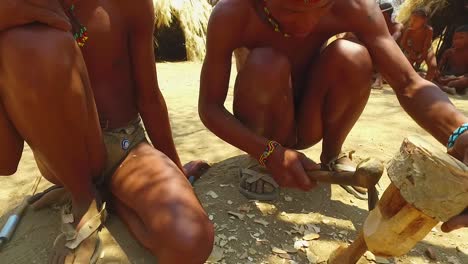 African-San-tribal-man-wood-carving-in-a-small-primitive-village-in-Namibia-Africa