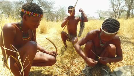 San-tribal-bushman-hunters-in-Namibia-Africa-walk-quiety-sniff-the-air-and-sample-the-soil-for-wind-direction-hunting-for-prey-2