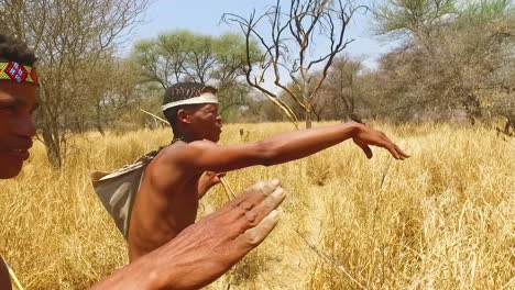 San-tribal-bushman-hunters-in-Namibia-Africa-walk-quiety-sniff-the-air-and-sample-the-soil-for-wind-direction-hunting-for-prey-6