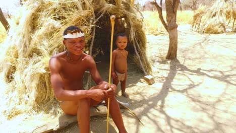 African-San-tribal-bushmen-family-at-their-huts-in-a-small-primitive-village-in-Namibia-Africa-3