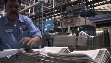 A-worker-stacks-newspapers-in-the-factory