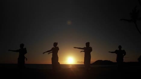 Native-Hawaiian-dancers-perform-in-the-distance-at-sunset-1