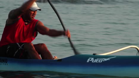 A-man-rows-an-outrigger-canoe-fast-
