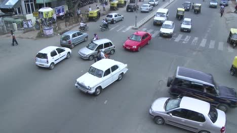 Vehicles-and-motorbikes-pass-through-a-busy-intersection-that-has-no-directional-signals