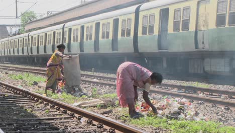 Women-set-fire-to-small-rubbish-piles-close-by-railroad-tracks