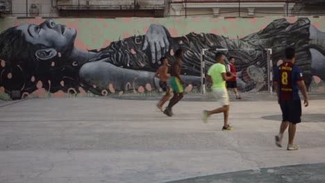 Poor-kids-play-soccer-in-front-of-a-beautiful-mural-in-Havana-Cuba