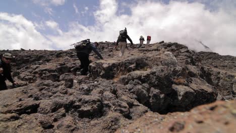 Trekkers-stepping-on-to-a-rocky-outcrop