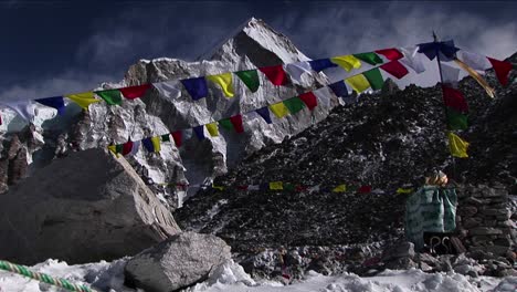 Puja-alter-with-prayer-flags-and-mountain-behind