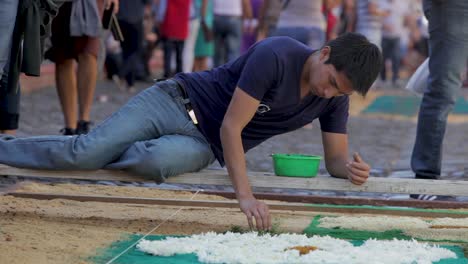 Locals-decorate-an-alfombra-or-carpet-during-Semana-Santa-Easter-week-in-Antigua-Guatemala